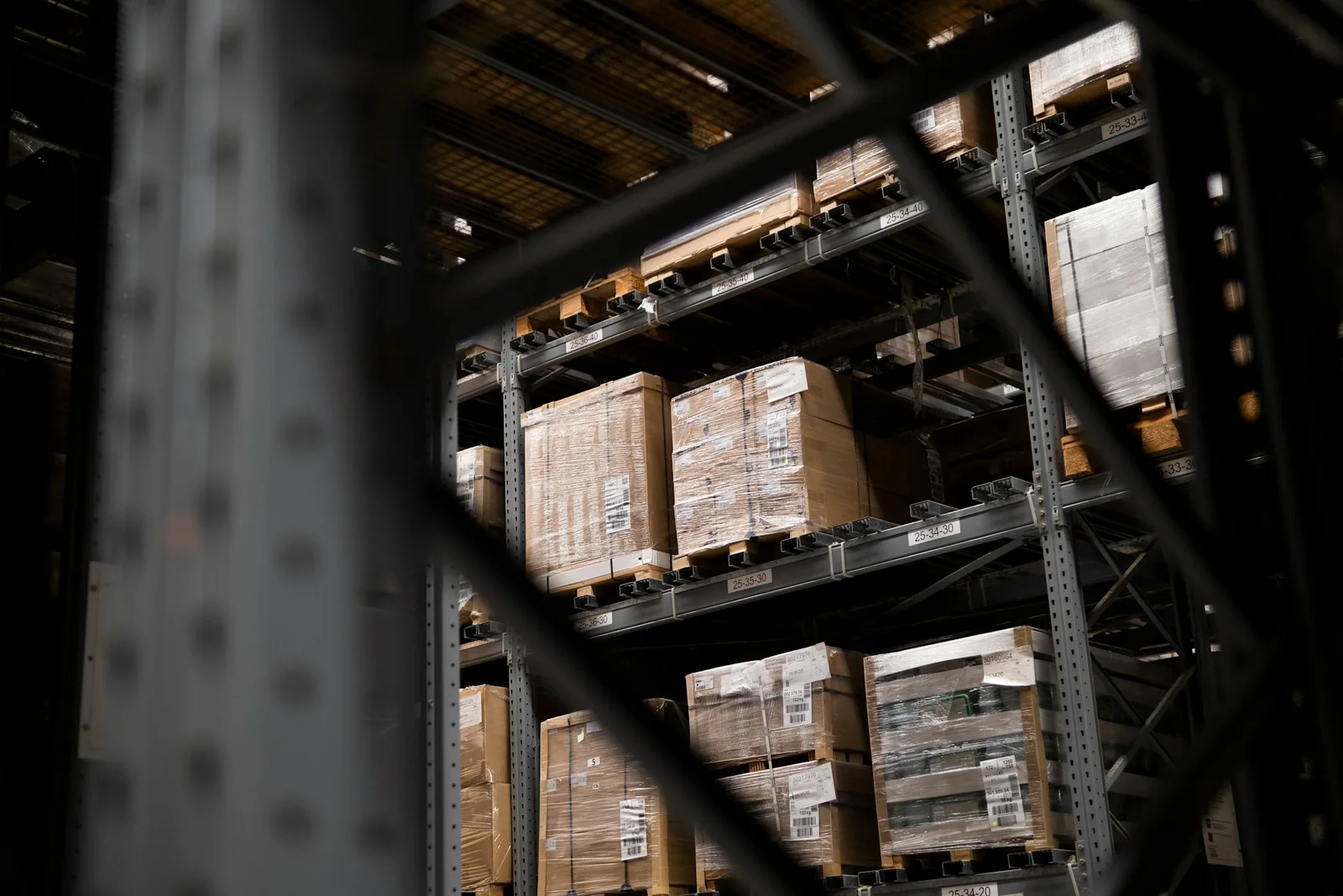 A warehouse filled with individual parcels and stacked wholesale pallets