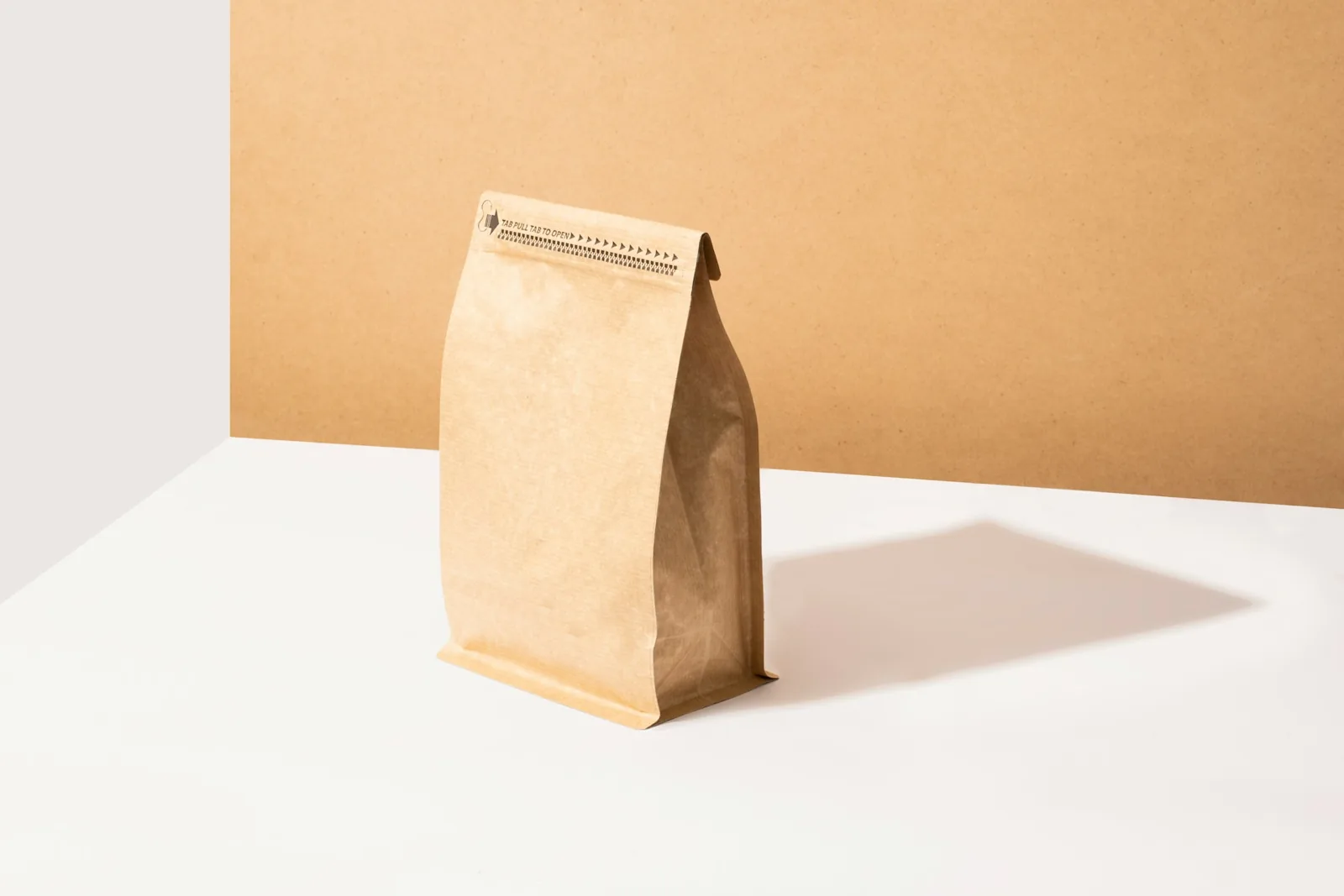 A brown kraft paper bag on a white table, an example of recyclable mono-material packaging design