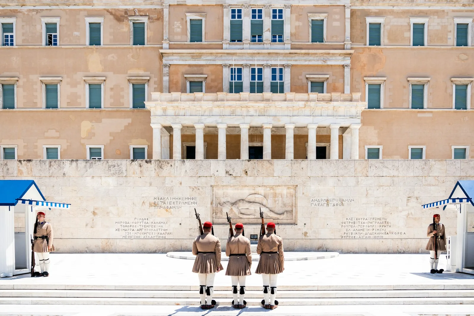 Evzones ceremonial guards standing watch at the Tomb of the Unknown Soldier in front of the Hellenic Parliament building in Athens