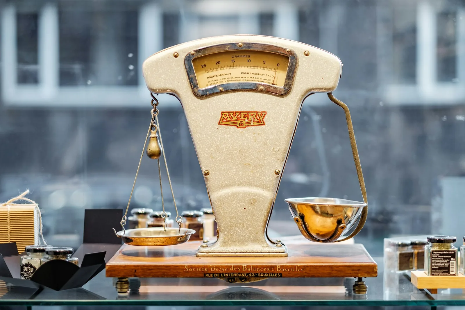 Brass balance scale weighing in grammes, representing weight-based EPR packaging fees