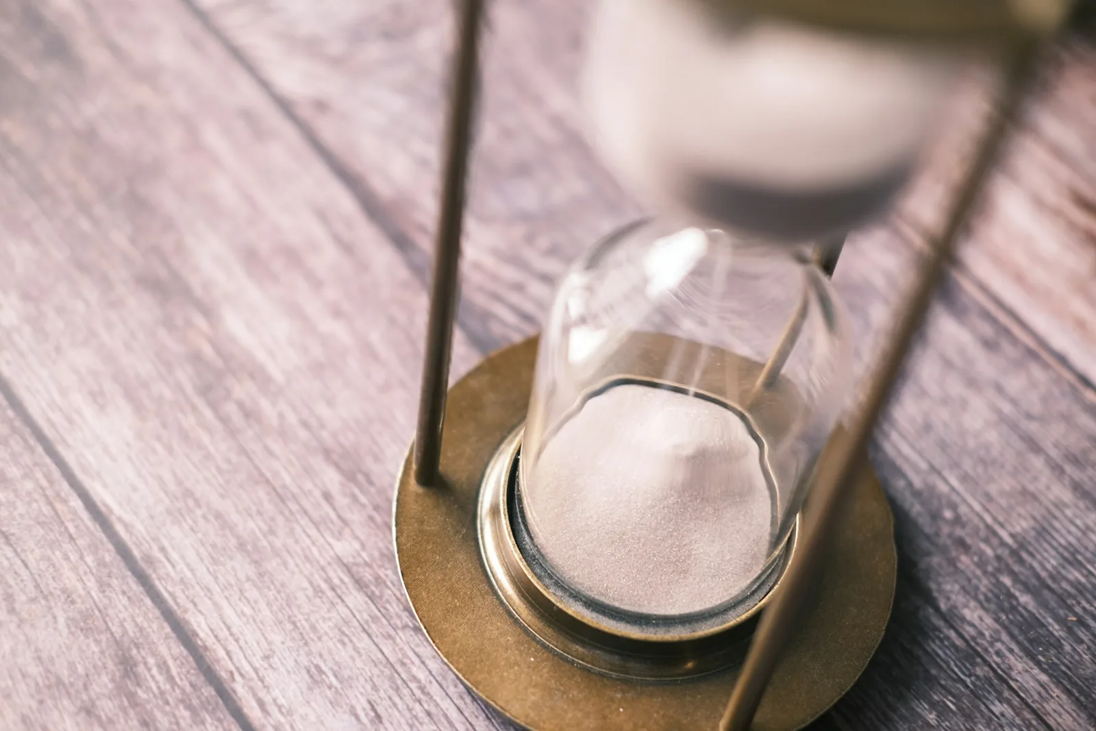 An hourglass on a wooden desk, evoking EPR registration processing lead times