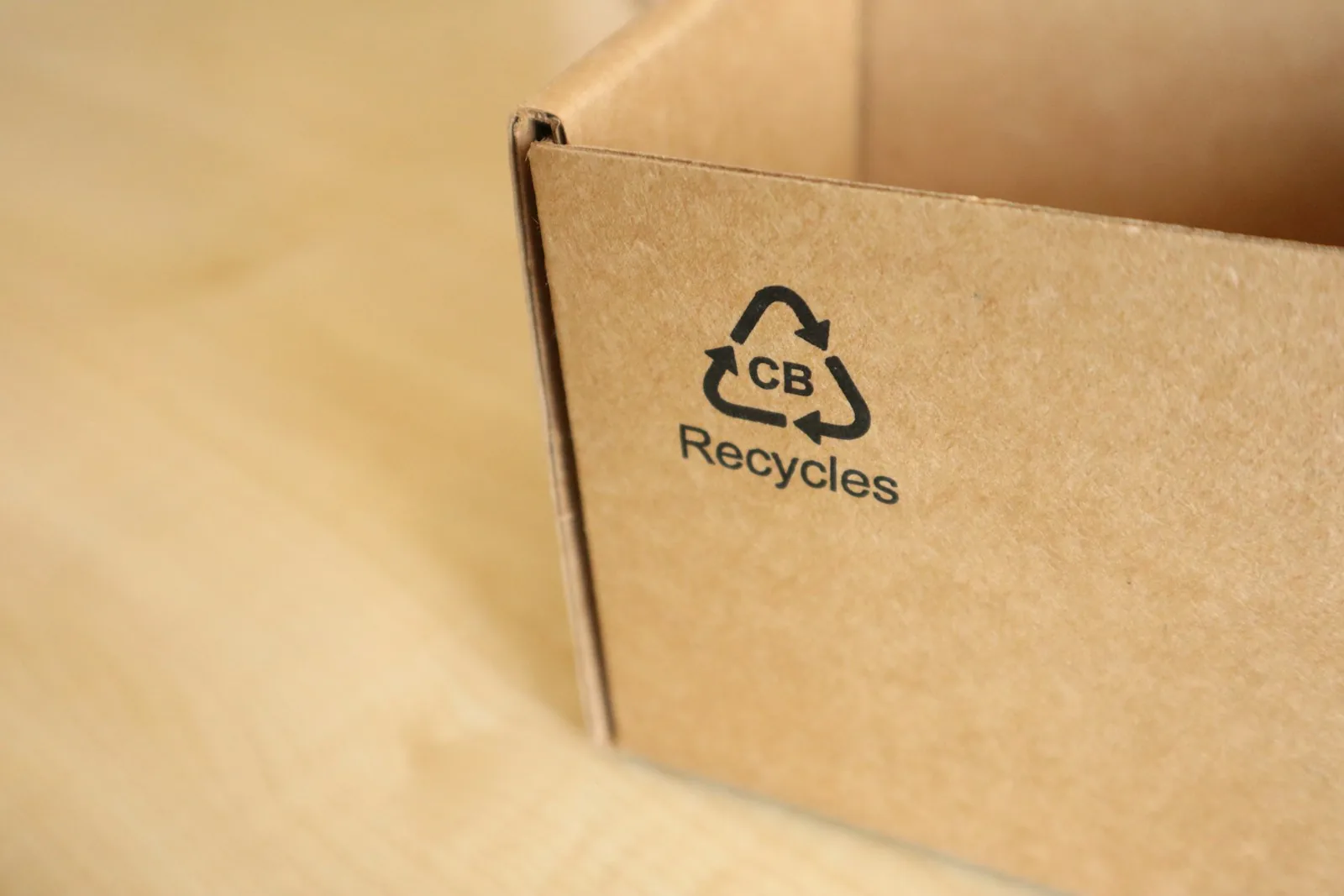 Close-up of a corrugated cardboard box printed with a mobius loop recycling symbol
