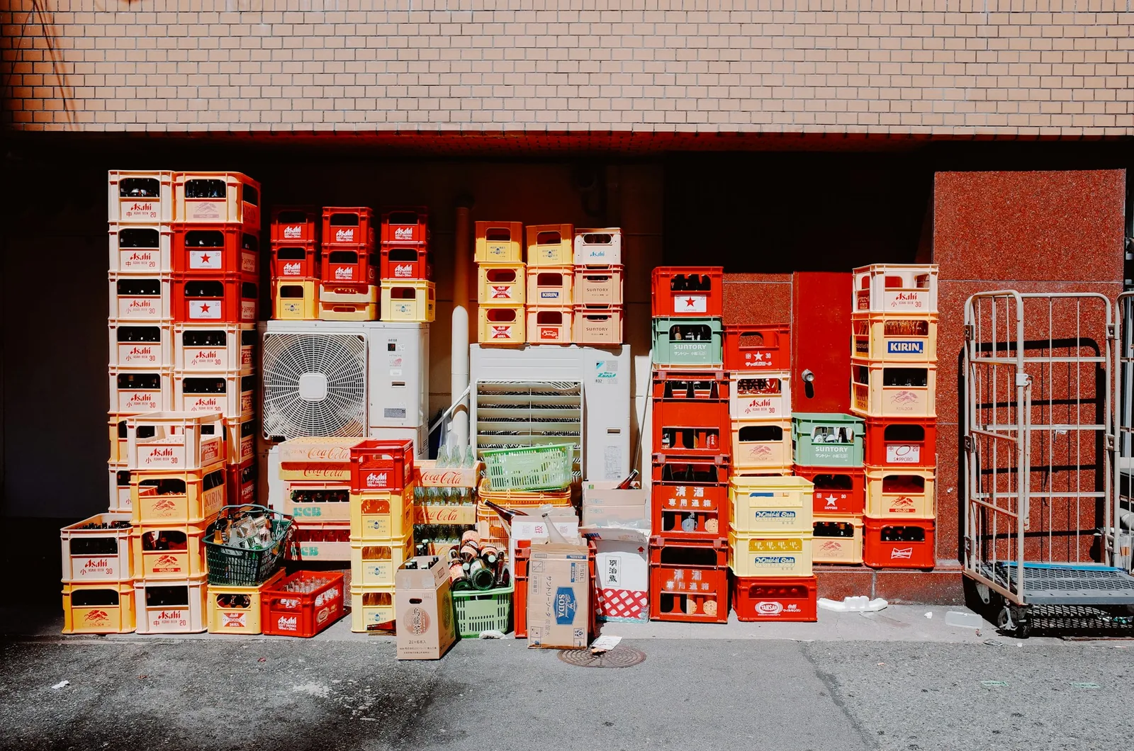 Stacks of colourful returnable beverage crates, a reusable packaging system